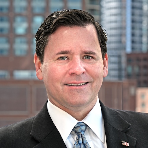 Photo of Bryan Keane with buildings behind