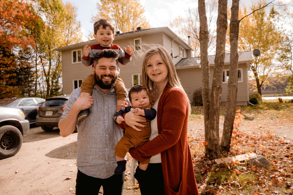 Happy family in front of their new home